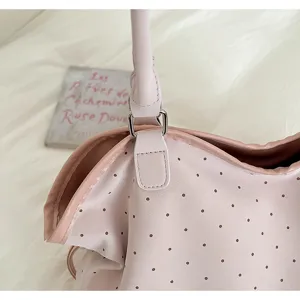 Korean style pink polka dot tote bag detail shot, featuring soft leather and shoulder strap.