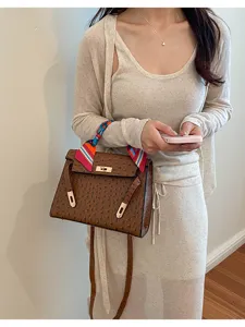 Classic retro brown ostrich pattern leather handbag for women, elegant top handle crossbody bag.