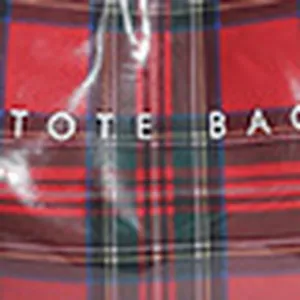 Detail view of the red and green plaid waterproof tote bag fabric, featuring clear texture.