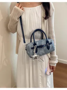 Chic denim crossbody bag featuring retro buckle strap and star charm for daily wear.