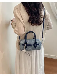 Retro denim shoulder bag for women, versatile crossbody handbag with stylish star charm details.