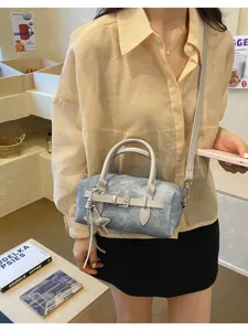 Retro denim crossbody bag for women, versatile small handbag with star pendant and strap.