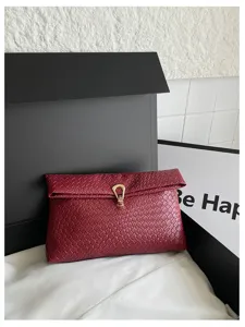 Geweven envelop clutch voor dames, elegante wijnrode handtas met stijlvolle metalen gesp.