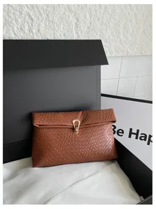 Bruine geweven enveloppe clutch tas voor vrouwen, minimalistische metalen gesp handtas chic.
