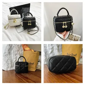 Quilted mini vanity bag detail, showing chain strap, zipper closure and bottom structure.