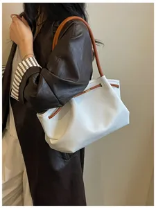 Detail shot of white hobo shoulder bag with brown straps and stylish chic design.