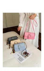 Stylish casual canvas crossbody bag for women with chic metal buckle and bead charm.