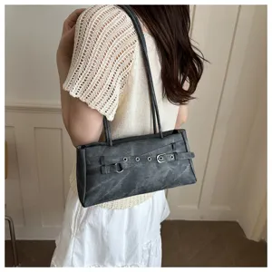 Close-up detail of the stylish denim shoulder underarm bag featuring a chic buckle belt design.