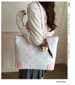 Stylish large capacity women tote bag with cute bear pendant, pink and white PU leather.