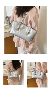 Silver metallic shoulder bag detail showing the unique knot handle design and stylish look.