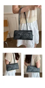 Detailed view of the dark grey distressed denim shoulder underarm bag with metal grommets.
