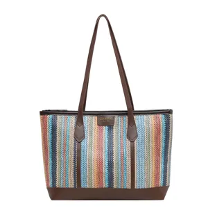 Colorful striped straw tote bag with brown leather handles, stylish summer beach shoulder bag.