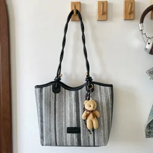 Color-block woven tote bag, casual travel handbag with chic braided handles and cute bear pendant.