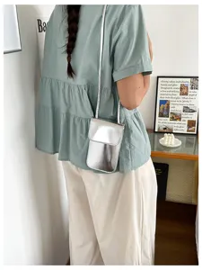 Stylish metallic silver crossbody phone bag for women, modern casual design with slim strap.
