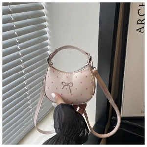 Bolso de mano con lunares y lazo bonito para mujer, detalle elegante de bolso cruzado.