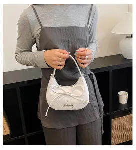 White crescent shoulder bag with bow detail, trendy hobo handbag, chic daily crossbody bag.
