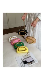 Mini round evening clutch bag with metal ring handle and chain strap for women chic daily wear.