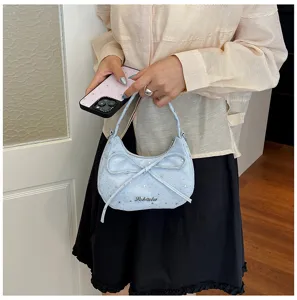 Light blue hobo shoulder bag detail, stylish bow and star pattern design for daily wear.