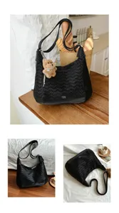 Stylish black shoulder tote bag with wave texture and cute bear pendant, perfect for daily casual wear.