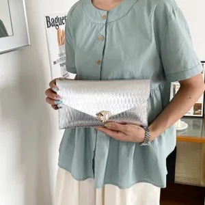 Silver envelope clutch bag for women, stylish Korean commuter handbag with metallic lock.