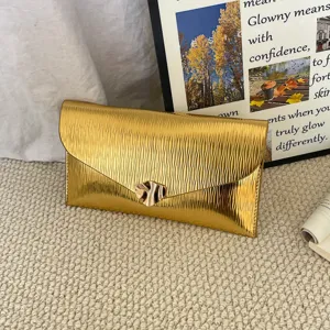 Stylish gold metallic envelope clutch bag featuring a textured pleated design and chic metal clasp.