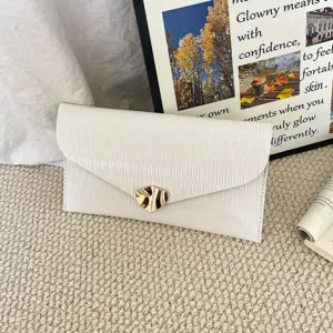 White textured envelope clutch bag with gold irregular metal clasp for women stylish commute.