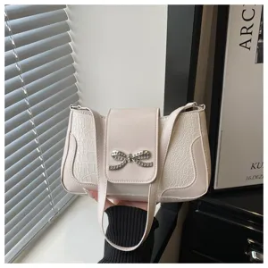 Elegante bolso de hombro para mujer con lazo de diamantes y diseño de textura cocodrilo.