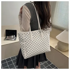 Detailed view of the stylish monogram printed tote bag showcased in a bright room.
