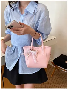 Pink leather bucket bag with cute lace pearl bow detail, stylish women handbag for daily use.