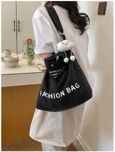 Japanese style canvas shoulder bag with fashion letters and cute cloud plush pendant detail.