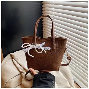 Trendy brown bucket bag for women, featuring pearl lace bow, large capacity commuter bag.