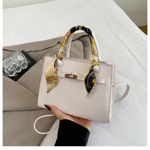 Stylish white women handbag with elegant silk scarf and metal lock design for daily wear.