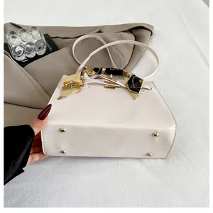 White women's top handle handbag with stylish silk scarf and golden hardware for daily use.