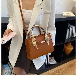 Chic women's top handle crossbody bag with stylish scarf accent and elegant faux leather finish.