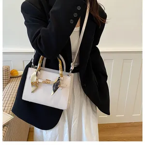 Women stylish top handle shoulder bag with twilly scarf detail and chic metal lock closure.