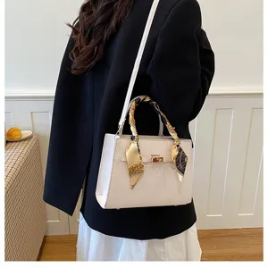 Elegant women's white leather handbag with stylish scarf accent, chic top handle shoulder bag.