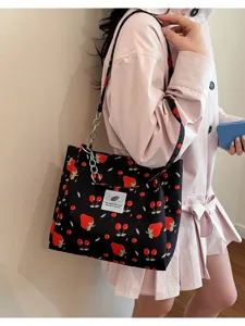 Close-up detail of the cute strawberry print canvas shoulder bag, casual everyday fashion.