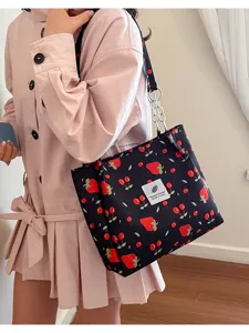 Stylish black cherry print tote bag with metal chain strap for women spring fashion.