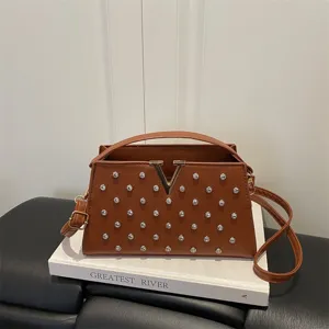 Élégant sac à bandoulière marron en cuir avec logo V et clous argentés pour femme.