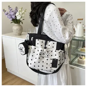 Detailed view of the black and white polka dot canvas backpack with cute bear graphic.