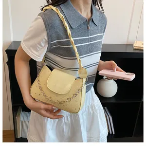 Yellow stylish shoulder bag for women with woven strap and chain decor, chic casual handbag.