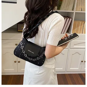 Chic black star pattern shoulder bag with chain detail, stylish crossbody bag for women.