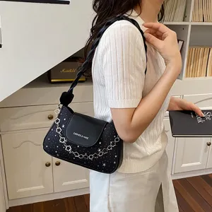 Stylish black underarm shoulder bag for women, featuring star print and chic chain strap design.