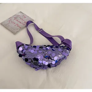 Close-up detail of the trendy purple sequin waist bag showing shimmering texture and adjustable strap.