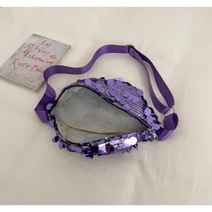 Detail view of purple sequin waist bag, showing sparkling sequin texture and strap.