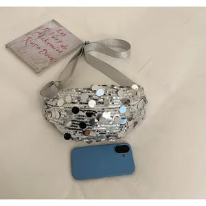 Detailed view of silver sequin waist bag showing sparkling texture and compact portable design.