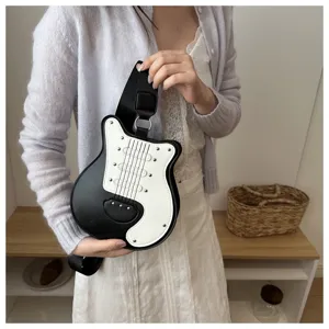 Detailed shot of unique guitar shaped crossbody bag in black and white with shoulder strap.