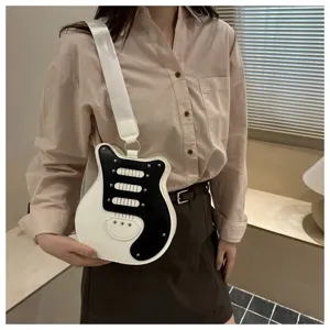 Detailed view of the unique guitar-shaped shoulder bag, black and white for travel.