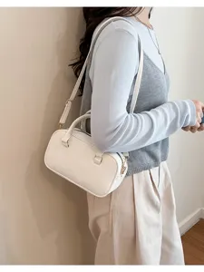 Detailed view of fashionable women white shoulder handbag and stylish crossbody bag.