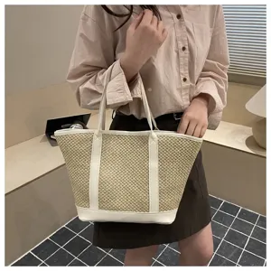 Detailed shot of the stylish summer straw tote bag featuring chic white PU leather trim.